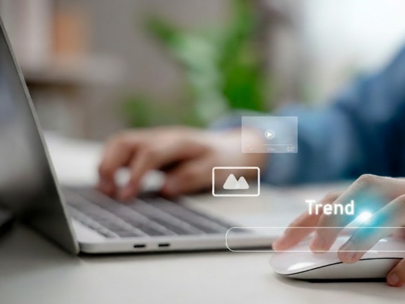 Marketer analyzing Facebook and Instagram ad trends on a laptop