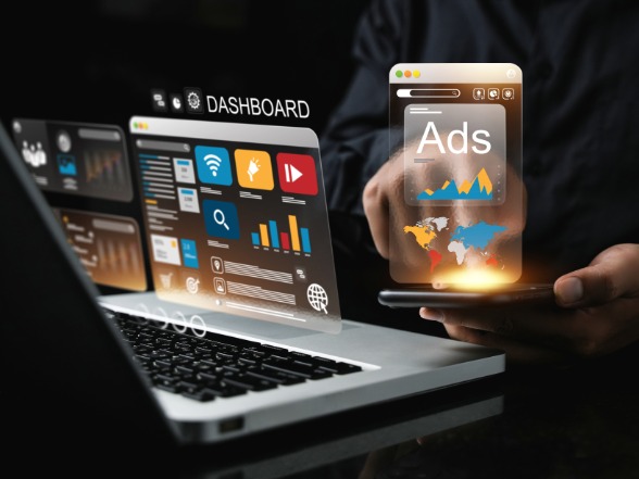 Google Ads management dashboard and campaign performance graphs on a laptop