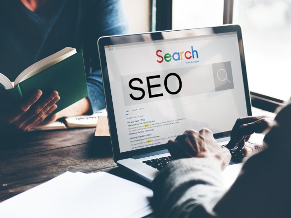 SEO search engine optimization results shown on a laptop screen