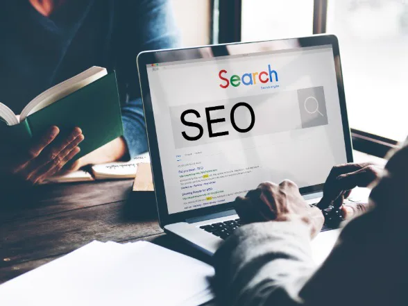SEO search engine optimization results shown on a laptop screen
