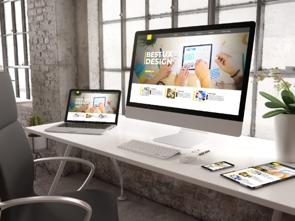 Responsive website design displayed across desktop, laptop, and mobile screens